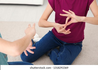 Hearing Impaired Mother And Her Child Talking With Help Of Sign Language Indoors, Closeup