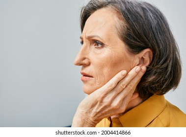 Hearing Loss. Mature Woman With Hearing Problems Touching Ear With Hand. Side View, Earache