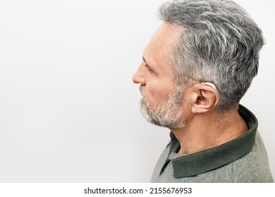 Hearing Loss Treatment Concept At Older People. Senior Man With Hearing Aid Behind The Ear Can Hear Sounds