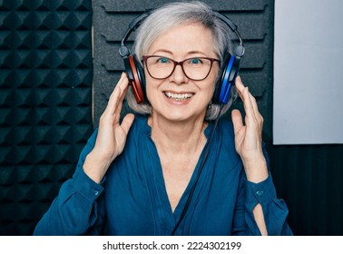Hearing Loss Treatment. Positive Mature Woman Wearing Audiometry Headphones While Hearing Test And Audiogram In Special Audio Room
