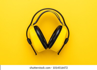 Hearing Protection Industrial Ear Muffs On Yellow Background