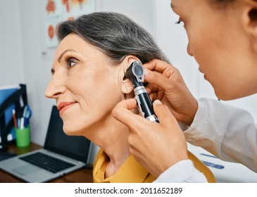 Hearing Test For Mature People, Otoscopy. Otolaryngologist Doctor Checking Senior Woman's Ear Using Otoscope Or Auriscope At Medical Center