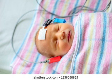 Hearing Test Of A Sleeping Newborn At Hospital