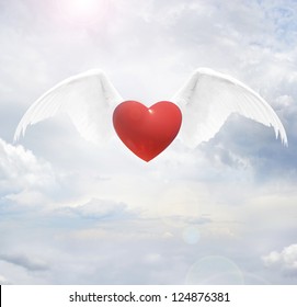 Heart With Angel Wings On Sky Background