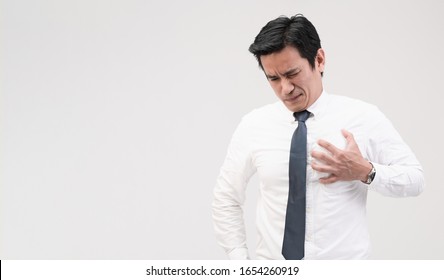 Heart Attack, Asian Office Worker Holding His Chest From Suffering From Heart Pain, Stressful Working, Caused By High Blood Pressure Or High Cholesterol, Concept Of Healthcare And Medical Treatment.