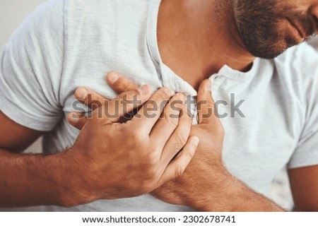 Heart attack, cardiovascular disease and man with chest pain, sickness or inflammation at his home. Medical emergency, healthcare and closeup of male person in cardiac arrest and injury at his house.