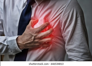 Heart attack concept. Man suffering from chest pain, closeup - Shutterstock ID 646534813