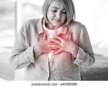 Heart Attack Concept. Senior Woman Suffering From Chest Pain Indoor