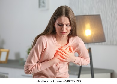 Heart Attack Concept. Woman Suffering From Chest Pain Indoor