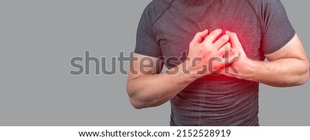 heart attack. Man clutching his chest from acute pain. Heart attack symptom. Severe heartache, man suffering from chest pain, having heart attack or painful cramps, pressing on chest