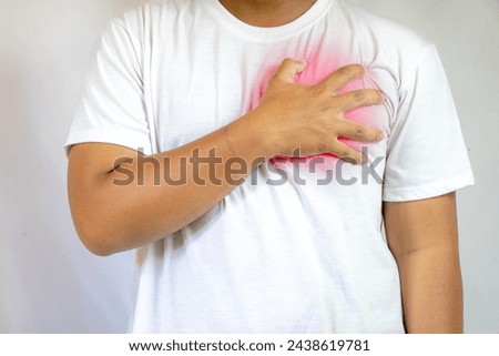 heart attack. Man clutching his chest from acute pain. Heart attack symptom. Severe heartache, man suffering from chest pain, having heart attack or painful cramps, pressing on chest
