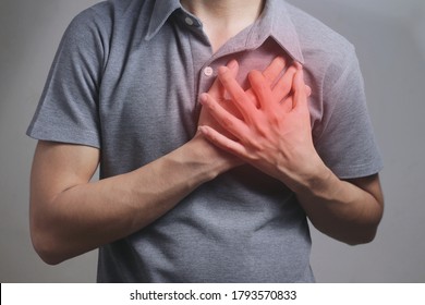 Heart attack problems. Young male suffering from severe chest pain. Warning signs of terrible disease. Health care and cardiological concept.
