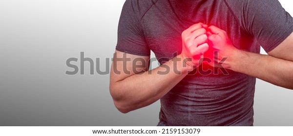heart attack. Severe heartache, man suffering\
from chest pain, having heart attack or painful cramps, pressing on\
chest with painful. Man clutching his chest from acute pain. Heart\
attack symptom