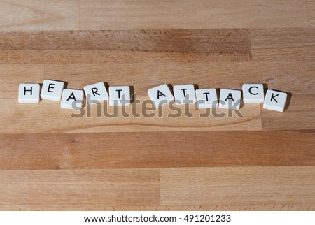 Heart attack text on a wooden table.