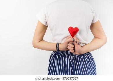 a heart behind woman's back isolated on white background - Shutterstock ID 576037387