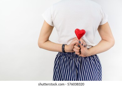 a heart behind woman's back isolated on white background  - Shutterstock ID 576038320