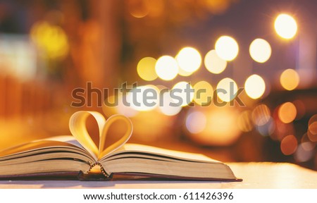 Heart from a book page vintage style close up heart shape from paper book with bokeh in soft light at night ,(blur background) ,copy space,concept for valentine's da