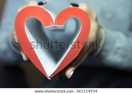 Heart from book pages with red edges