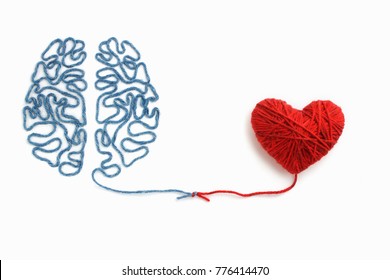 Heart and brain connected by a knot on a white background - Shutterstock ID 776414470