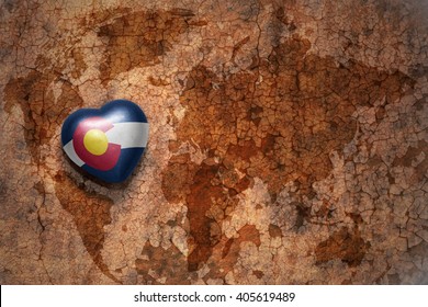 Heart With Colorado State Flag  On A Vintage World Map Crack Paper Background. Concept