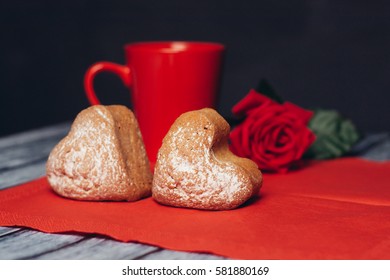 heart cookies on a red napkin, a red circle and a red rose.