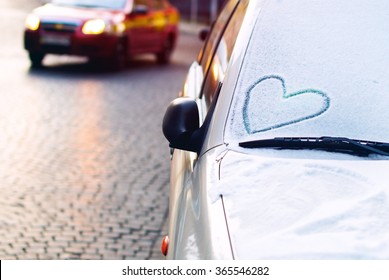 Heart Drawn On A Car Windscreen Covered With Snow