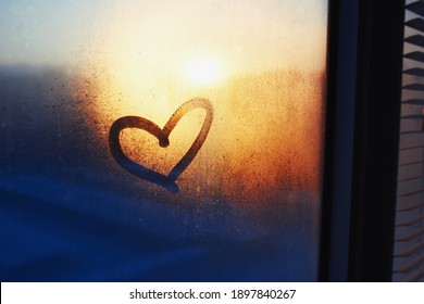 Heart Drawn On A Misty Window And Sunset On The Background