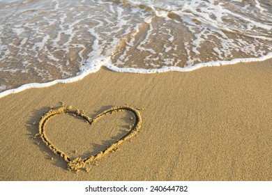 Heart drawn on the sand of a beach.