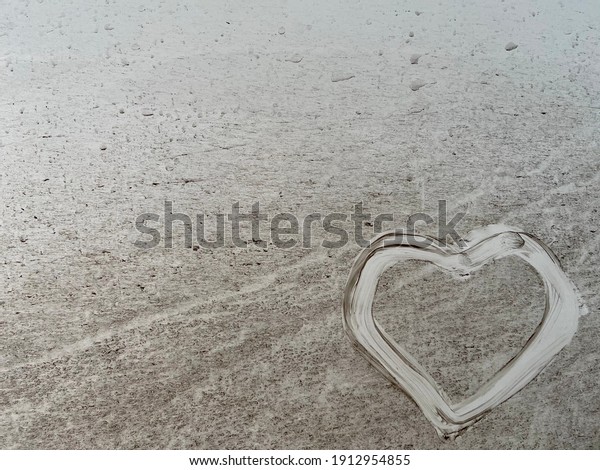 Heart drawn on white color car chassis\
under valentine day concept for unyielding\
couples