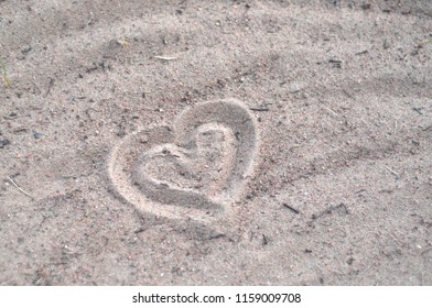 Heart drawn in the sand.