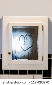 Heart Drawn In Steamy Mirror In Retro Art Deco Bathroom With Black And White Tile And Gold Knobs