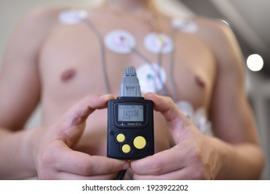 Heart electrocardiogram or monitoring using Holter for young patient. Male athlete does a cardiac stress test. wearing Holter monitor device for daily monitoring of an electrocardiogram.  - Shutterstock ID 1923922202
