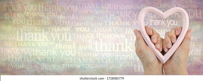 Heart felt thank you background banner -  female hands holding a pink flesh coloured heart frame against a grunge rustic graduated background of many different sized words of thank you 
 - Powered by Shutterstock