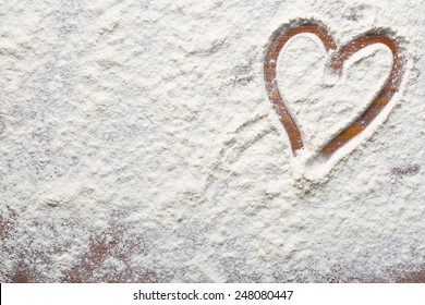 heart of flour on wooden table