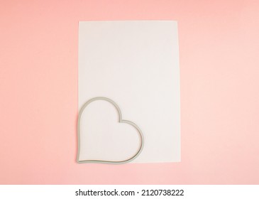 Heart Frame And FLYER A4 Mock Up Blank Template Design Idea. Heart Frame Mockup Against Pastel Pink Background. Copy Space Templates Designs For Message Layout.