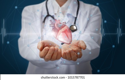 Heart in the hands of the medical worker on blue background.