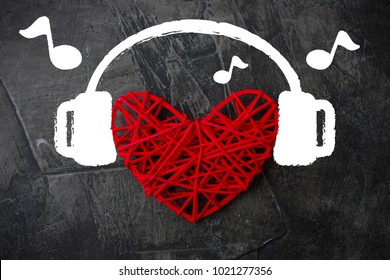 Heart in headphones on a dark background. Theme for Valentine's Day. Wedding, love 1