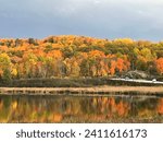 In the heart of Huntsville, Ontario, autumn unfurls its vibrant canvas, transforming the landscape into a mesmerizing display of vivid colors. The iconic Muskoka region becomes a tapestry of warm hues