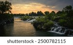 The Heart of Idaho Falls over the Snake River Waterfront at Sunrise in Bonneville County, Idaho, USA: The serene waterfalls flowing through the center of town