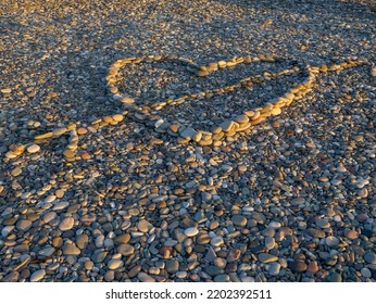 Heart Laid Out With Stones On Stones. Heart Hit By An Arrow. Love Sign. Resort On The Sea. A Beautiful Symbol. A Holiday Romance