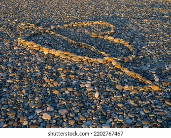 Heart Laid Out With Stones On Stones. Heart Hit By An Arrow. Love Sign. Resort On The Sea. A Beautiful Symbol. A Holiday Romance