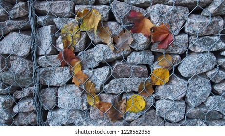 Heart Of Leaves On A Stone Wall Behind Bars