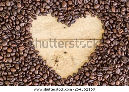 heart love space for sample text of coffee beans on wood