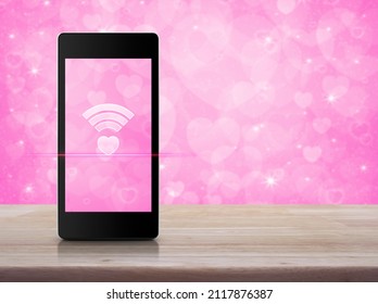 Heart Love Wifi Flat Icon On Modern Smart Mobile Phone Screen On Wooden Table Over Blur Pink Wall, Internet Love Online, Valentines Day Concept