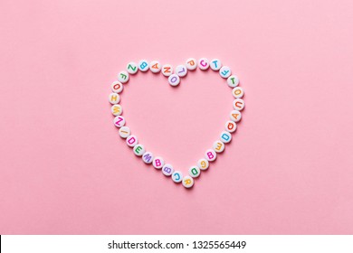 Heart Made Of Alphabet Letter Blocks On Pink Background, Creative Valentine's Day Card, Love Reading Concept