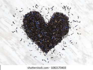 Heart Made Of Black Earl Gray Tea Leaves, On Marble Background. Tea Love.