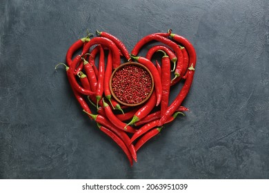 Heart Made Of Chili Peppers And Bowl With Red Peppercorns On Dark Background