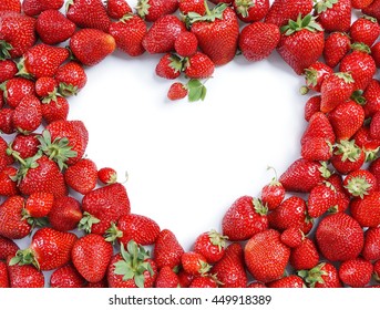 Heart made from deluxe strawberry on white background. Copy space. Top view, high resolution product.