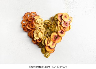 Heart Made Of Dried Sliced Plums, Kiwi, Peach Chips On White Background. Fall Harvest. Home Drying. Snack Vegan Free Sugar Food.