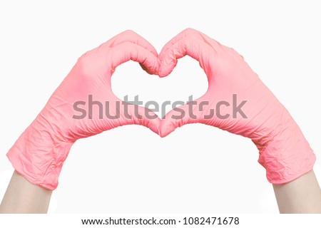 Heart made of pink medical gloves isolated on white background
